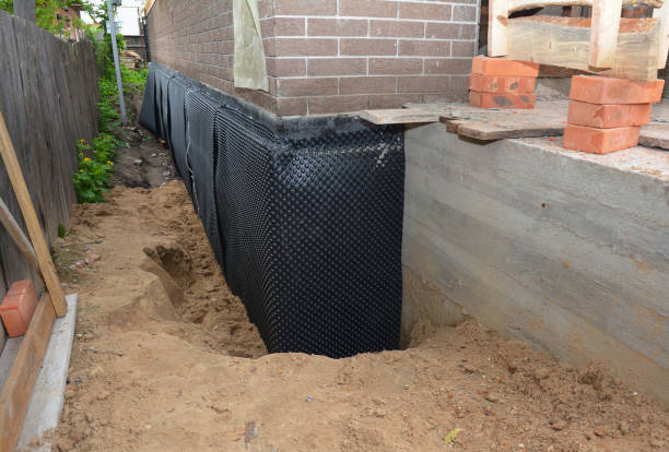 SJ Waterproofing Pros technician performing targeted Basement Waterproofing assessment in Glenbeulah, WI